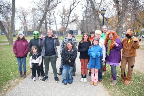 Brandon Zombie Walk participants, dressed in zombie costumes, stand in Stanley Park before setting out on a roughly 3.5-kilometre walk through the city on Sunday afternoon. (Abiola Odutola/The Brandon Sun)