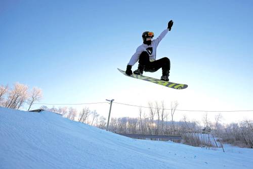 A snowboarder sails off a box in the terrain park at Asessippi Ski Resort in this file photo. The resort is expected to make an announcement about operational impacts due to flood damage by Nov. 6. (Tim Smith/The Brandon Sun files)