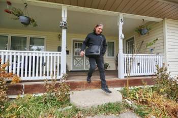 Incumbent mayoral candidate Jeff Fawcett steps down from the front porch of a home in Ward 3 while door-knocking in the area on Tuesday before today's municipal election. (Matt Goerzen/The Brandon Sun)