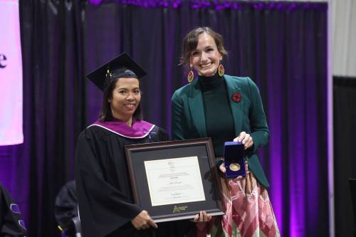 Manitoba Advanced Education Minister Renée Cable presents the Governor General&rsquo;s Academic Medal and plaque to early childhood education program grad Julia Dionisio during Friday&rsquo;s fall graduation ceremony. (Abiola Odutola/The Brandon Sun)
