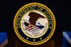 FILE - The U.S. Department of Justice logo is seen on a podium before a news conference, May 4, 2026, in Washington. (AP Photo/Julia Demaree Nikhinson, File)