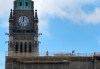 A worker stands on top of the Centre Block buildings below the Peace Tower on Parliament Hill in Ottawa on Tuesday, Sept. 8, 2026. THE CANADIAN PRESS/Adrian Wyld