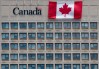 A giant Canadian flag hangs on the side of a government office building in downtown Ottawa, Tuesday, June 30, 2020. THE CANADIAN PRESS/Adrian Wyld