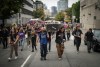 Andrew Leavens, front left, and Carl Gladue, front right, carry an empty coffin during a march organized by the Vancouver Area Network of Drug Users (VANDU) to mark International Overdose Awareness Day, in Vancouver, on Thursday, Aug. 31, 2023. THE CANADIAN PRESS/Darryl Dyck