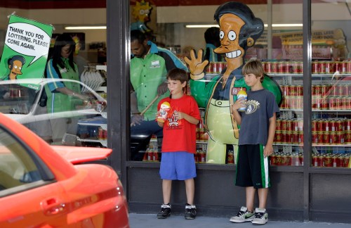 FILE - Children appear next to a window display featuring 