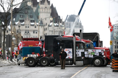 Trucks are seen in front of the Chateau Laurier hotel as a protest marked by gridlock and blaring horns reached its 14th day in Ottawa on Thursday, Feb. 10, 2022. THE CANADIAN PRESS/Justin Tang
