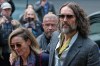 Comedian and actor Russell Brand, accompanied by his wife Laura Brand, arrives at Southwark Crown Court in London, Monday, Oct. 19, 2026 where he is charged with counts of rape and sexual assault against six women.(AP Photo/Kirsty Wigglesworth)