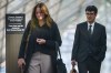 Author and former University of British Columbia professor Steven Galloway, back right, and his wife Katie Wagner are seen through a window as they leave B.C. Supreme Court during a lunch break at his defamation lawsuit, in Vancouver, on Tuesday, Oct. 6, 2026. THE CANADIAN PRESS/Darryl Dyck