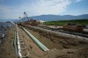 Workers lay pipe during construction of the Trans Mountain pipeline expansion on farmland, in Abbotsford, B.C., on Wednesday, May 3, 2023. THE CANADIAN PRESS/Darryl Dyck