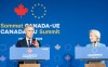 Prime Minister Mark Carney speaks to the media as European Commission President Ursula von der Leyen, right, looks on during for their closing press conference during the EU-Canada summit in Montreal on Friday, Oct. 30, 2026. THE CANADIAN PRESS/Christinne Muschi