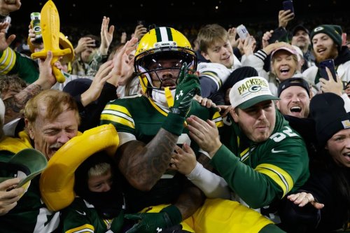 Green Bay Packers wide receiver Matthew Golden leaps into the stands as he celebrates scoring a touchdown during the first half of an NFL football game against the Carolina Panthersin Green Bay, Wis., Thursday, Oct. 29, 2026. (AP Photo/Mike Roemer)