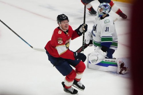 Florida Panthers left wing Brady Tkachuk (8) celebrates after scoring the game winning goal against Vancouver Canucks goaltender Leevi Meriläinen (31) during overtime in an NHL hockey game, Thursday, Oct. 15, 2026, in Sunrise, Fla. (AP Photo/Lynne Sladky)
