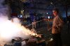 A man tries to extinguish a fire during clashes between protesters and police in Paris, Sunday, Oct. 18, 2026. (AP Photo/Emma Da Silva)