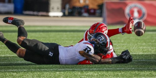 Ottawa Redblacks' Justin Hardy, front, dives for a pass against the Calgary Stampeders during first half CFL football action in Calgary, Saturday, Sept. 19, 2026. THE CANADIAN PRESS/Jeff McIntosh