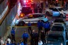 Police officers near the scene where a federal immigration agent shot a man in the Marble Hill neighborhood of New York City on Thursday, Oct. 8, 2026. A police spokesman said the person who was shot had been taken to a nearby hospital and was conscious and receiving medical attention. (Dakota Santiago/The New York Times)