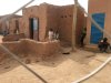 FILE - In this photo taken Sunday, April 15, 2018, children look on from behind a wire fence that separates their town from the current airport, in Agadez, Niger. (AP Photo/Carley Petesch, File)