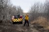 Firefighters work along a firewall next to CFB Wainwright, south of the town of Wainwright, Alta., on Monday, Oct. 19, 2026. THE CANADIAN PRESS/Christopher Katsarov