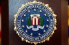 FILE - An FBI seal is displayed on a podium before a news conference at the field office in Portland, Ore., Jan. 16, 2025. (AP Photo/Jenny Kane, File)