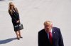 President Donald Trump speaks to the reporters as he walks to board Marine One on the South Lawn of the White House, Tuesday, Oct. 13, 2026, in Washington, as White House press secretary Katie Zacharia looks on. (AP Photo/Julia Demaree Nikhinson)