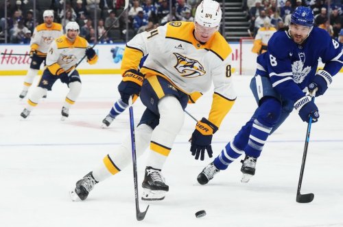 Nashville Predators' Adam Edstrom (84) moves past Toronto Maple Leafs' Chris Tanev (8) during first period NHL hockey action in Toronto on Tuesday, Oct. 6, 2026. THE CANADIAN PRESS/Nathan Denette
