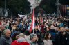 A young man holds a Serbian flag as people gather for the final 